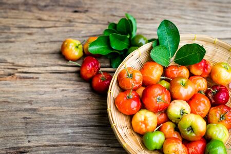 Fresh organic Acerola cherry on old wood background.の写真素材
