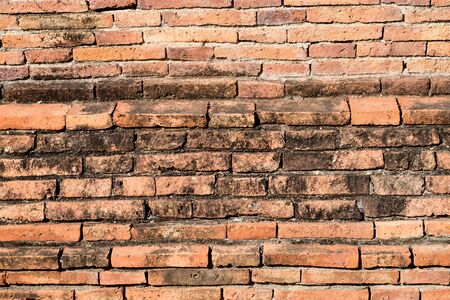 old red brick wall of Thai temple fenceの写真素材