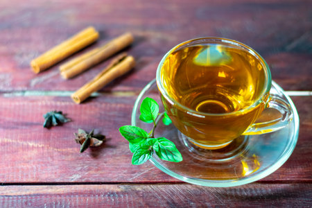 Mint tea on wooden table with fresh mint leaves and cinnamonの写真素材