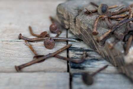 Old, damaged and rusty nails on the old wooden tableの写真素材