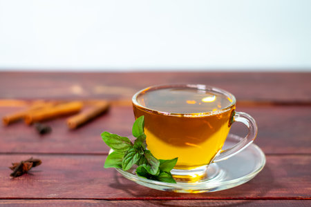 Mint tea on wooden table with fresh mint leaves and cinnamonの写真素材