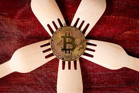 Bitcoin with wooden spoon on wooden backgroundの写真素材
