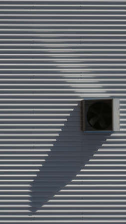 Industrial background of metal wall and pipesの写真素材