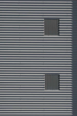 Industrial background of metal wall and pipesの写真素材