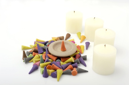 A pile of the incense cones with candle.の写真素材