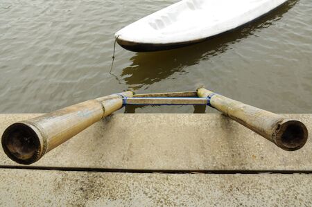 Bamboo ladder and white canoeの写真素材