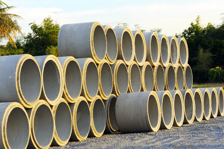A pile of concrete pipe with sunset light.の写真素材