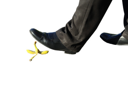 Business man walk over a banana peel.の写真素材