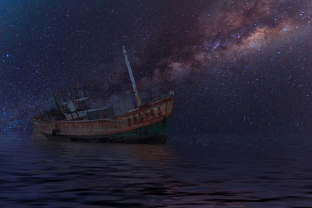 The wrecked ship under starry night with clearly  milky wayの写真素材