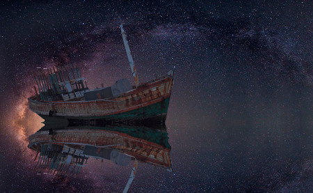 The wrecked ship under starry night with clearly  milky wayの写真素材