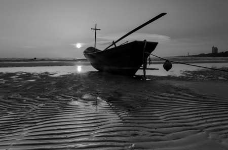 Fishing boat at the beach during sunset in black and white, Thailandの写真素材