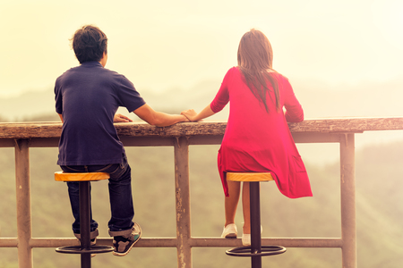 Happy young romantic couple looking at a beautiful landscape scene. Traveling and Relax Concept.の写真素材