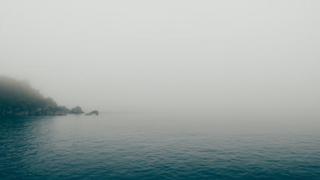 The sea hills and sand are covered with fog and spray scary mystery ocean and mountains Tourist attraction 3d illustrationの写真素材