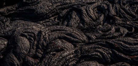 The lava surface cools and hardens into rock Clumps of dark black lavaの写真素材