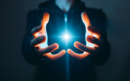 Two hands held out There is a glowing blue light ball technology concept in handの素材