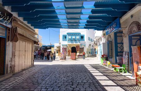 KAIROUAN, TUNISIA - APRIL 9: Tourists and locals in the traditional medina market in Kairouan, Tunisia on April 9, 2018のeditorial素材