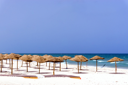 Landscape of empty beach covered with umbrellas in Sousse, Tunisia.の写真素材