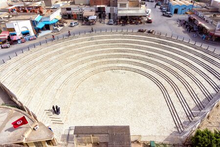 DJEM, TUNISIA - APRIL 7:View of the exterior entrance of the El Jem amphitheater with the background of El Djem town in Tunisia on April 7, 2018.のeditorial素材