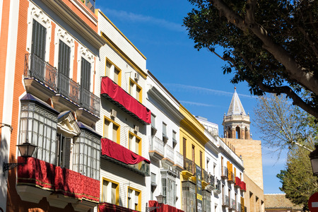 Colorful buildings with church spire view in Seville, Spainの写真素材