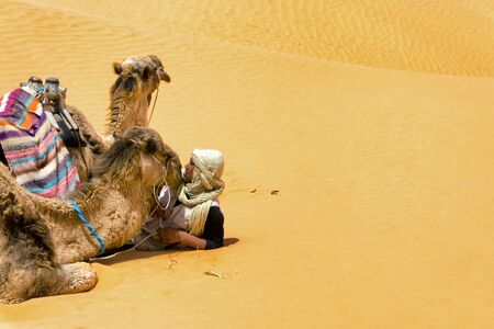 SAHARA, TUNISIA- APRIL 13: View of Sahara desert in Tunisia with man and two camels on April 13, 2018のeditorial素材