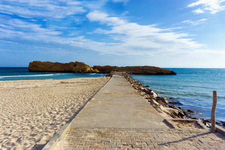 Landscape of the Al Qurayyah beach with the background of the Mediterrenean sea in Monastir, Tunisiaの写真素材
