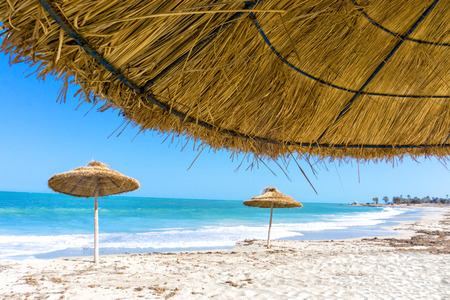 Landscape of parasols on the beach of Djerba in Tunisiaの写真素材