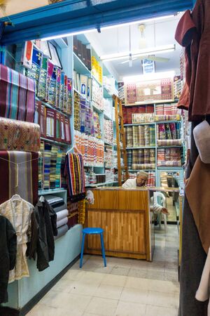 DJERBA, TUNISIA- APRIL 16: Variety of traditional cloths for sale in market in  in Houmt El Souk in Djerba, Tunisia on Aplil 16, 2018.のeditorial素材