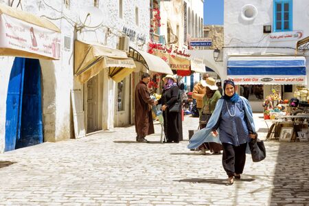 DJERBA, TUNISIA- APRIL 16: Tourists and locals in the traditional medina market in Houmt El Souk in Djerba, Tunisia on April 16, 2018のeditorial素材