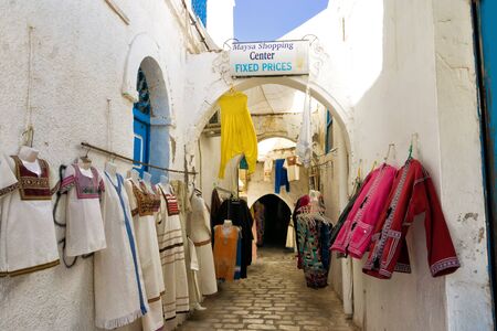 DJERBA, TUNISIA- APRIL 16: Variety of traditional clothing  for sale on the street in Houmt El Souk in Djerba, Tunisia on Aplil 16, 2018.のeditorial素材