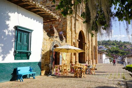 CURITI, COLOMBIA - FEBRUARY 22: Colorful colonial street with church and coffee shop in Curiti, Santander, Colombia on February 22, 2019のeditorial素材