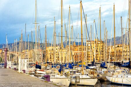 View of the Palermo port with boats and the city in the background in Sicily, Italyの写真素材