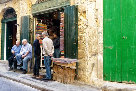 VALLETTA, MALTA - MAY 4: Group of men in store in Valletta, Malta on May 4, 2018のeditorial素材