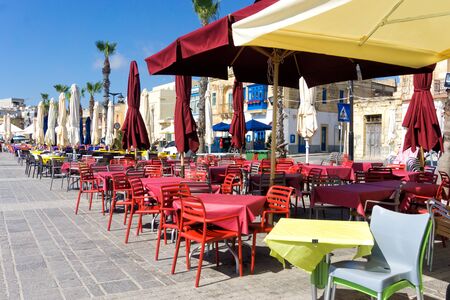 View of the waterfront restaurant area in Marsaxlokk, Maltaの写真素材