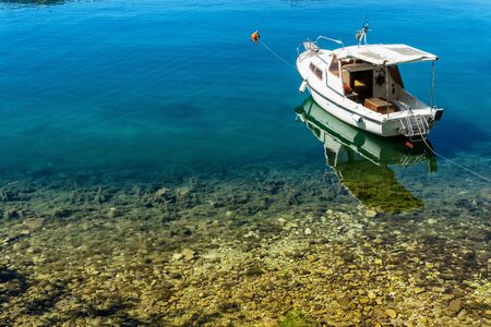 Old boat on the shore in Kotor, Montenegroの写真素材