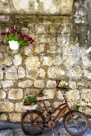 Bicycle in old town Perast on the wall in Montenegroの写真素材