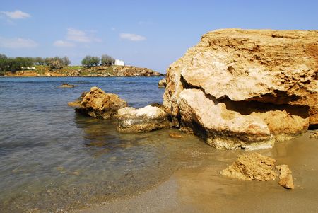 cliff on the beach of Agios Apostolis with the chapel as backgroundの写真素材