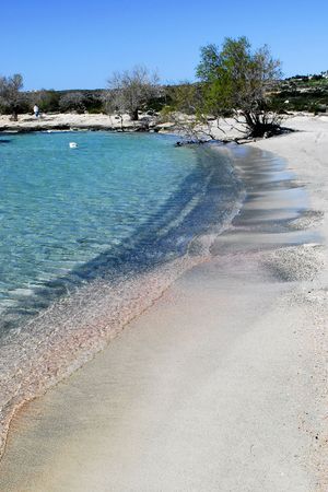 pink and black sand where the waves splashの写真素材