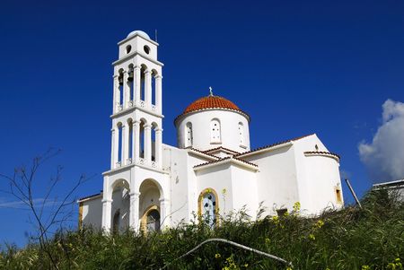 An old orthodox cretan church. Blue sky as background.の写真素材