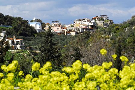 an old village and its church on the hill with the cloudy sky as backgroundの写真素材