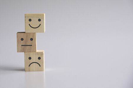 Wooden cube block stacking with icon face, The best excellent business services rating customer experience, Satisfaction survey conceptの写真素材