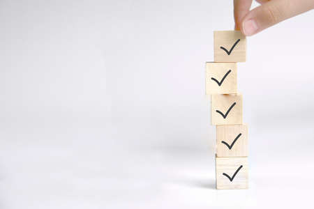 Checklist concept, Check mark on wooden blocks, blue backgroundの写真素材