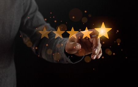 Satisfaction close up on customer man hand pressing on screen with five star rating feedback icon...