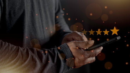 Satisfaction close up on customer man hand pressing on screen with five star rating feedback icon and press level excellent rank for giving best score point to review the service conceptの写真素材