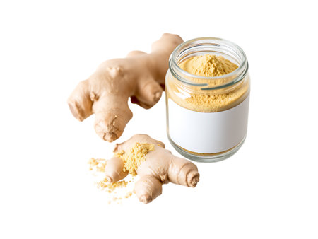 Ginger powder in glass jar and ginger root isolated on white backgroundの素材