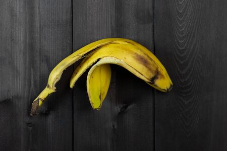 Banana peel on a background of wood.Banana peel on a background of woodの写真素材