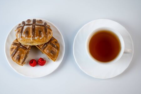 Gingerbread cookies with raspberries and tea on a white background.Gingerbread cookies with raspberries and tea on a white backgroundの写真素材