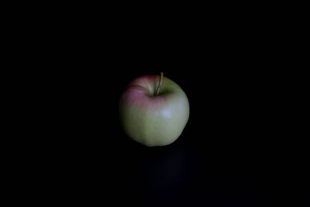Red-pink apple on a black background.Red-pink apple on a black backgroundの写真素材
