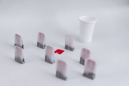 Tea bag and platik cups on a white background.Tea bag and platik cups on a white backgroundの写真素材