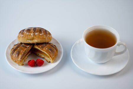 Gingerbread cookies with raspberries and tea on a white background.Gingerbread cookies with raspberries and tea on a white backgroundの写真素材