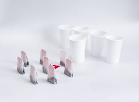 Tea bag and platik cups on a white background.Tea bag and platik cups on a white backgroundの写真素材